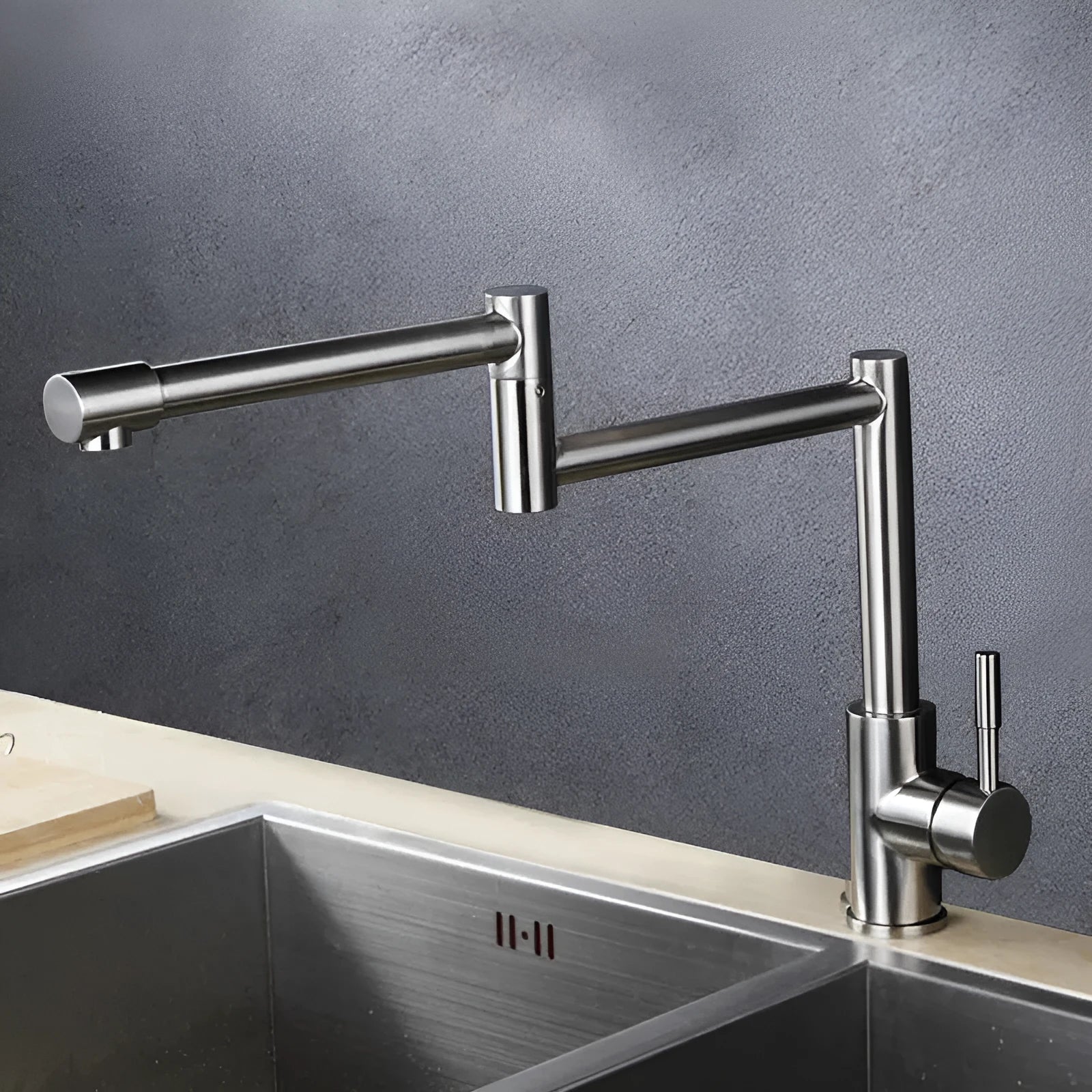 Silver stainless steel dual-control kitchen tap showing 360-degree rotation capability