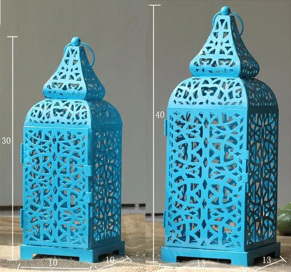 Blue Moroccan style geometric iron candlestick holder with hollow design for decorative lighting.