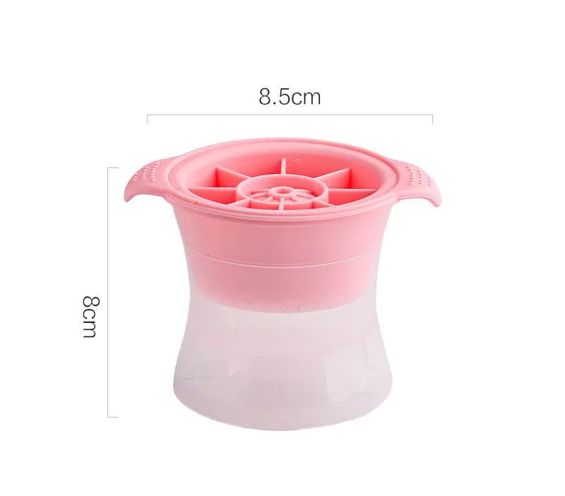 Flexible silicone ice tray producing large hockey puck-shaped ice cubes and other decorative shapes like spheres and pentagons.