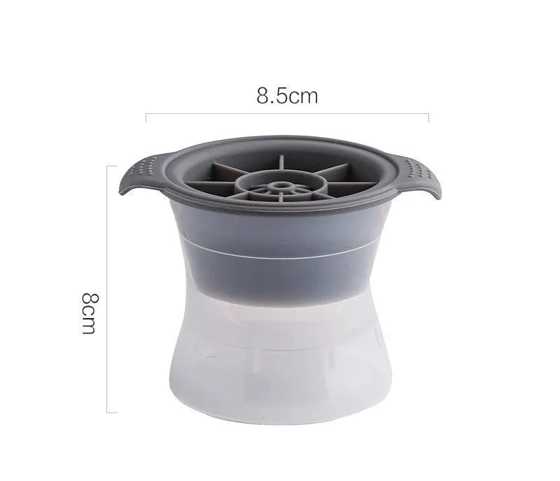 Flexible silicone ice tray producing large hockey puck-shaped ice cubes and other decorative shapes like spheres and pentagons.
