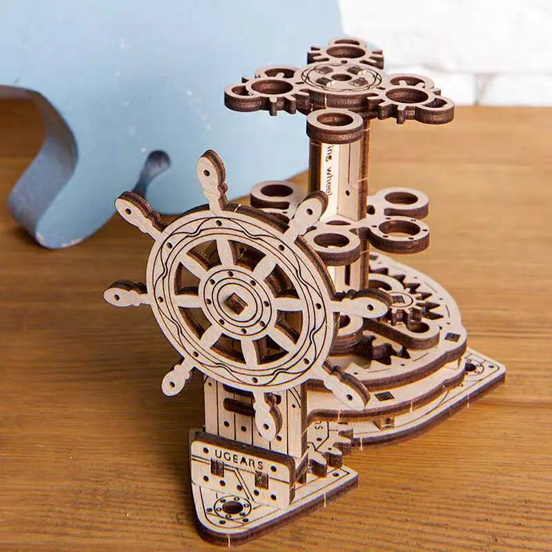 Ukrainian wooden rotating pen holder model with steering wheel mechanism on wooden base