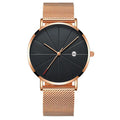Calendar thin mens watch with round dial, stainless steel mesh band, and pin buckle clasp on a wrist
