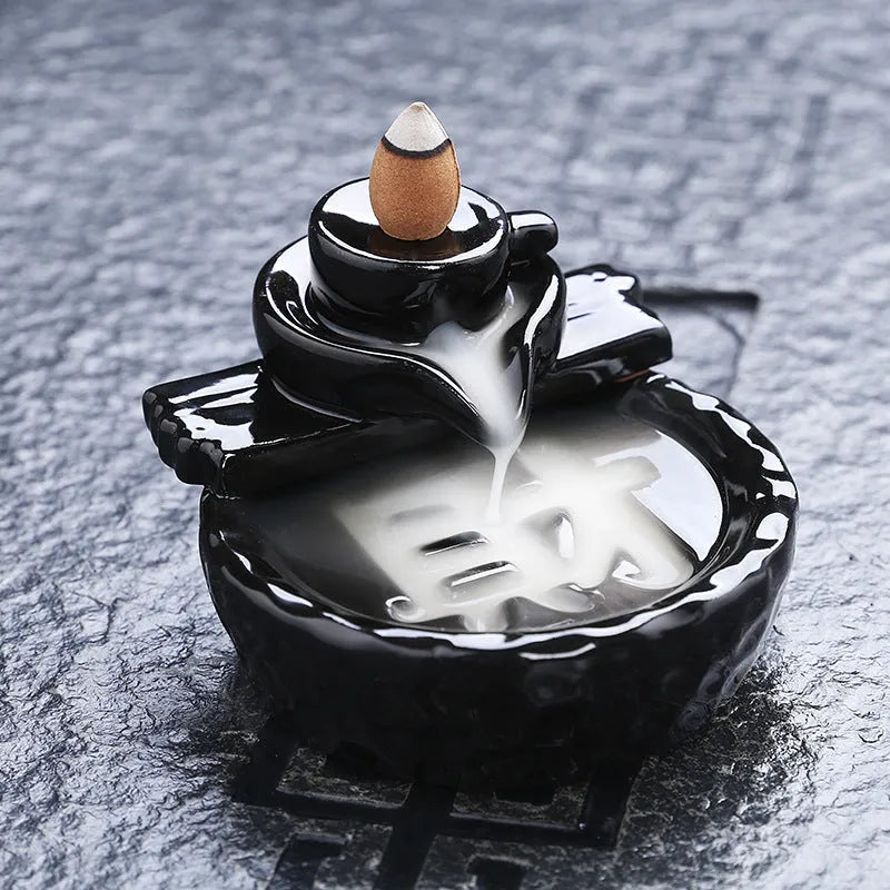 Ceramic backflow incense burner with black glaze finish and waterfall smoke effect