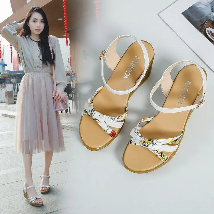 Women's pink wedge sandals with a thick heel, fish mouth style, and a buckle strap.