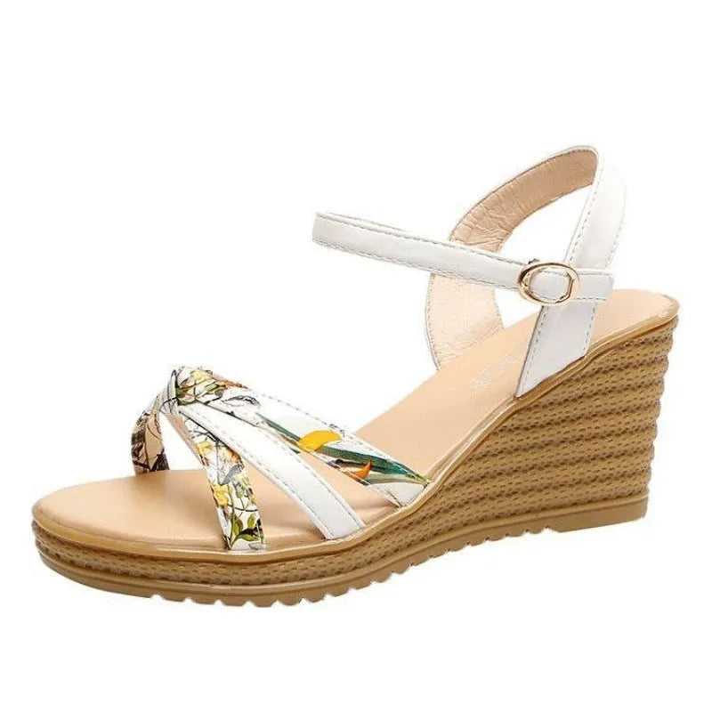 Women's pink wedge sandals with a thick heel, fish mouth style, and a buckle strap.
