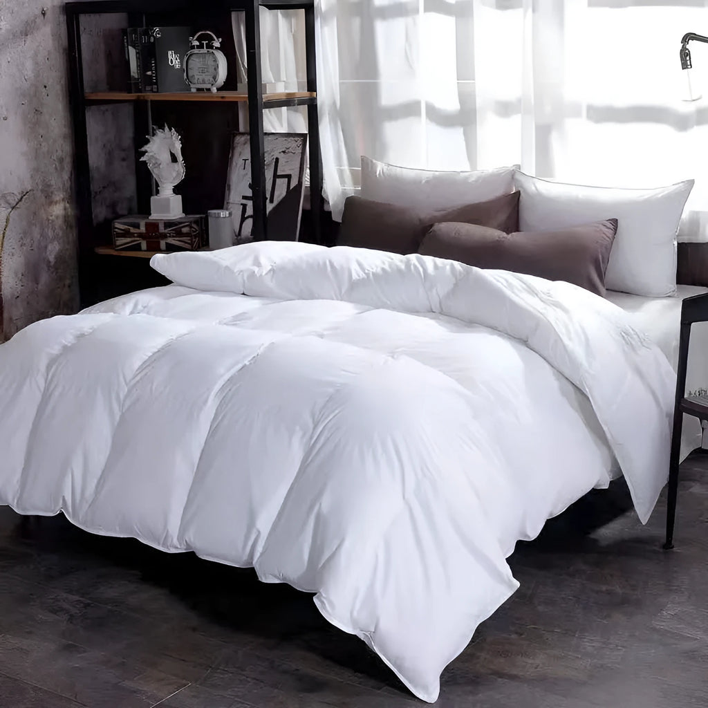 Goose down winter duvet in twill fabric shown in a light grey colour on a bed.
