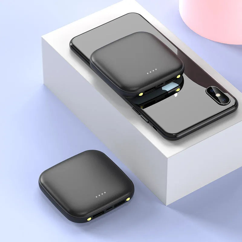 Compact square black power bank with 20000mAh capacity and a small LED flashlight on the front.