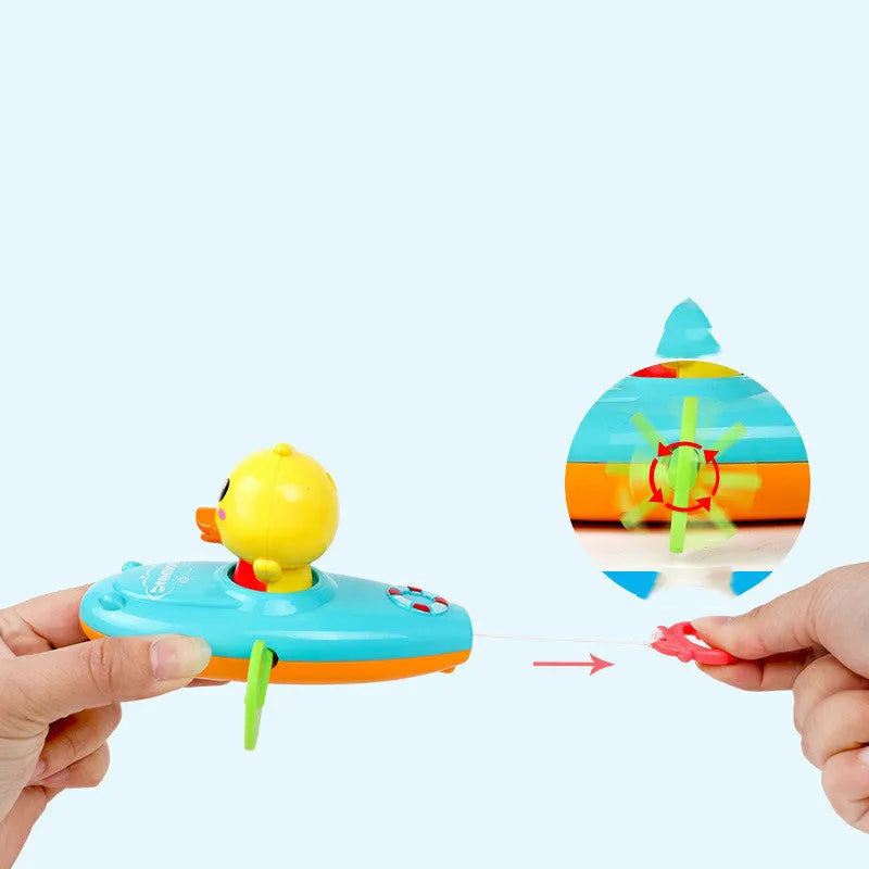 Yellow plastic wind-up duck bath toy swimming in water.