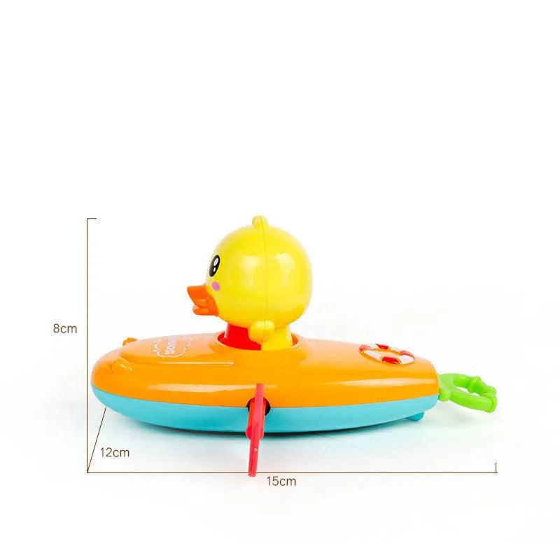 Yellow plastic wind-up duck bath toy swimming in water.
