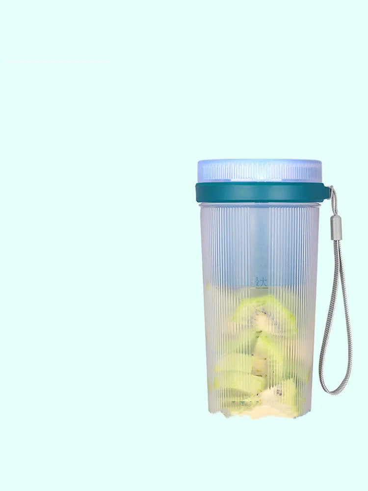 Small pink and green portable electric juicer cup with USB charging cable.