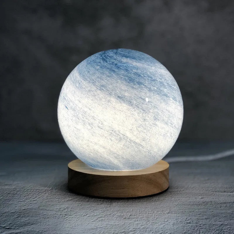 Nordic style USB table lamp with a glass shade shown in a choice of colours on a bedside table.