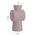 Nordic Morandi simple hammer ceramic vase in beige on a white surface, decorative ornament for home