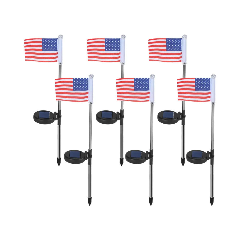 Solar-powered stainless steel garden flag light showing American flag design with white LEDs illuminated.