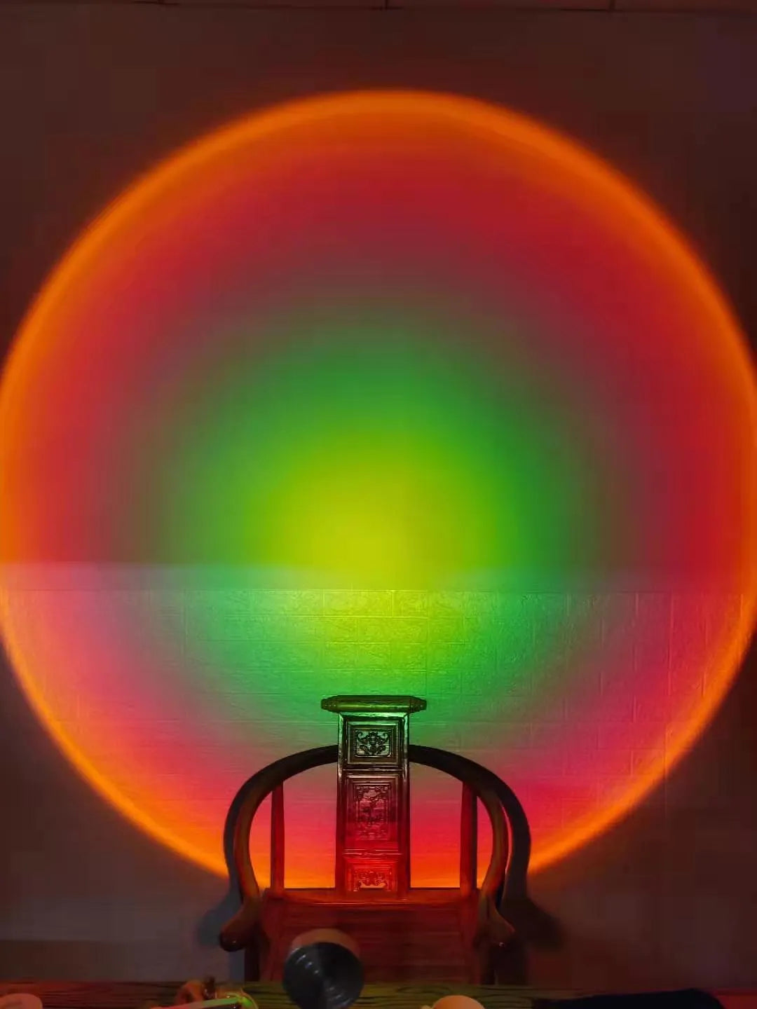 WiFi LED sunset projector light with 16 RGB colours, 360° rotation, glass lampshade, and touch switch on a table