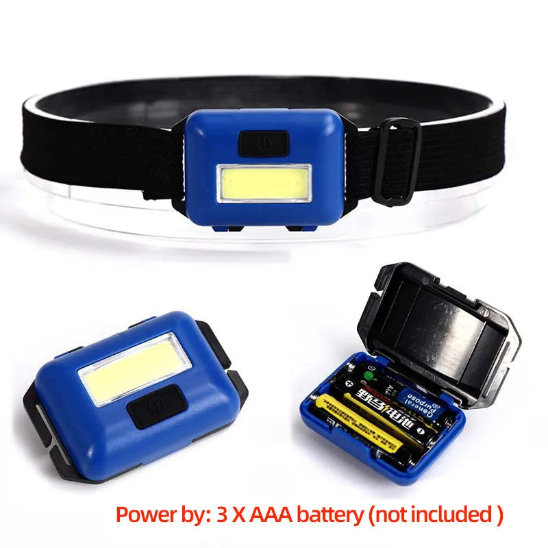 Small blue outdoor LED headlight with adjustable polyester strap on a dark background.