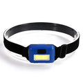 Small blue outdoor LED headlight with adjustable polyester strap on a dark background.