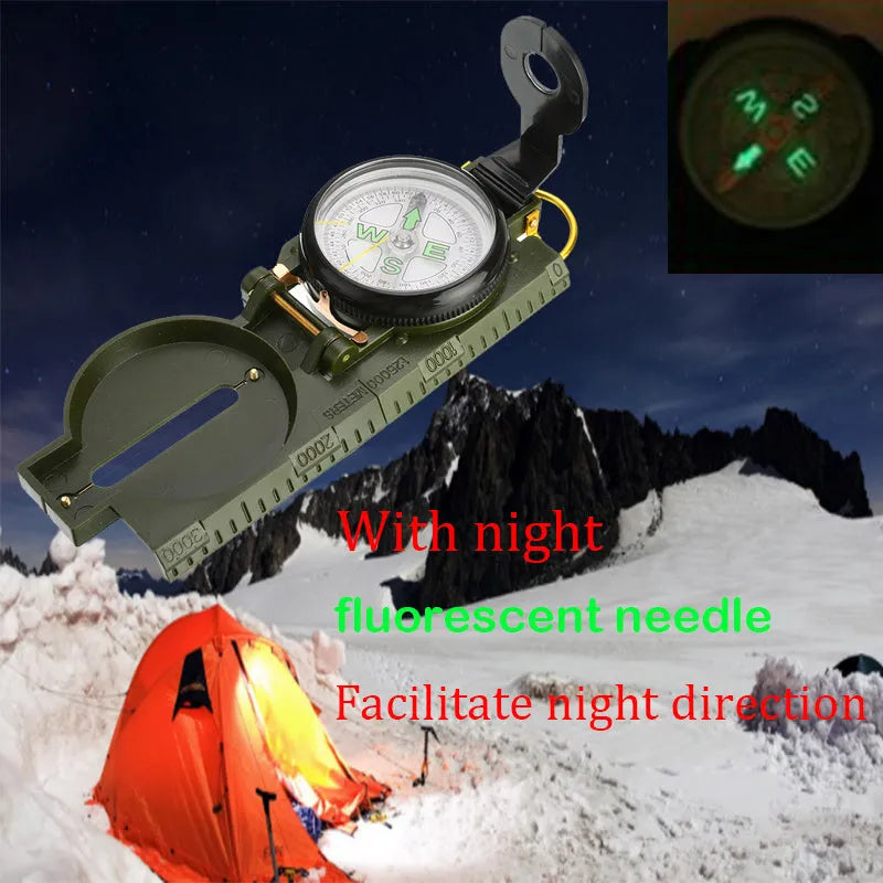 Army yellow outdoor camping compass with carabiner clip on a metal background