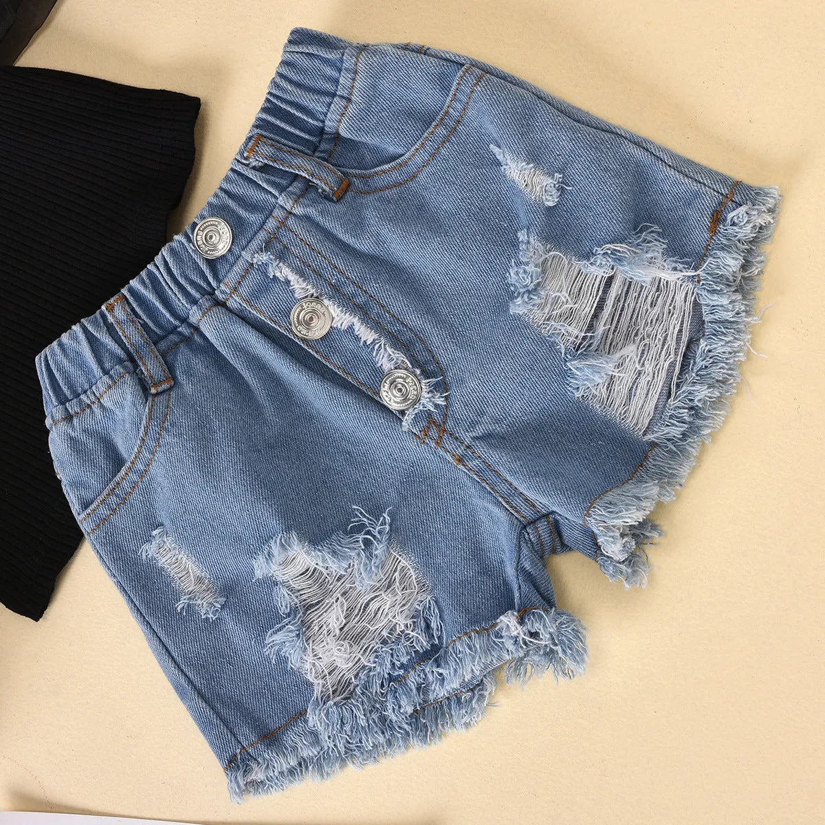 Children's cotton striped top with dot mesh sleeves and ripped denim shorts suit in black on a child