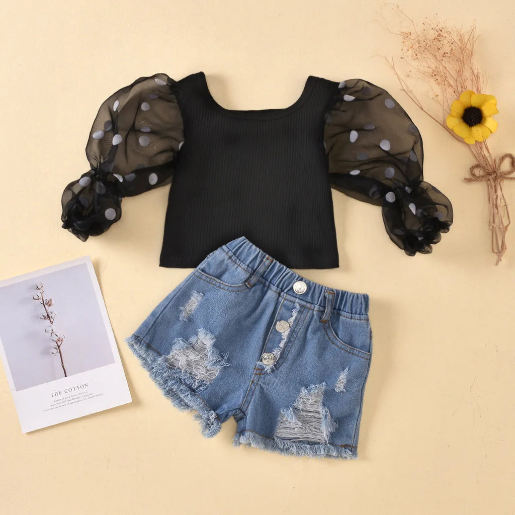 Children's cotton striped top with dot mesh sleeves and ripped denim shorts suit in black on a child