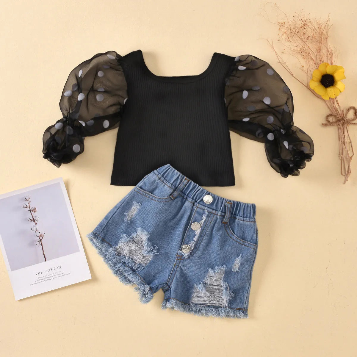 Children's cotton striped top with dot mesh sleeves and ripped denim shorts suit in black on a child
