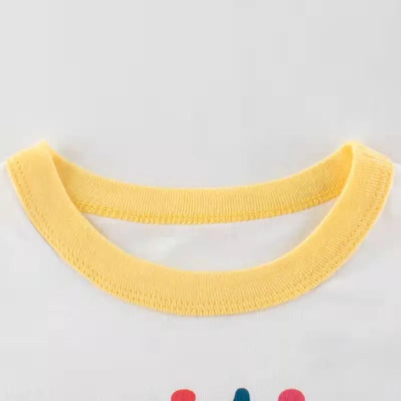 White girls summer t-shirt with alphabet pattern and cartoon design, short sleeves, on a child model, showing soft fabric