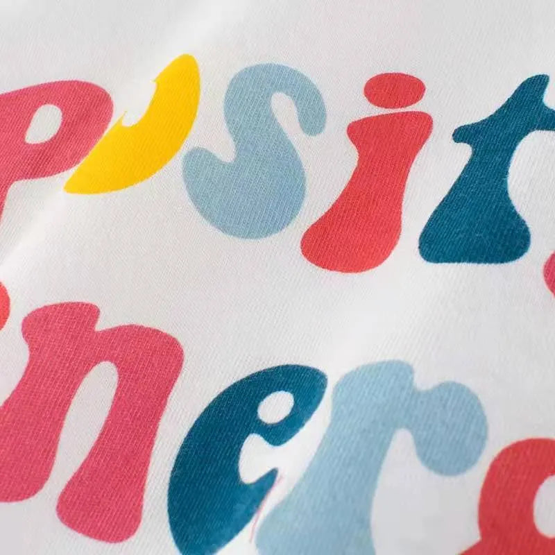 White girls summer t-shirt with alphabet pattern and cartoon design, short sleeves, on a child model, showing soft fabric