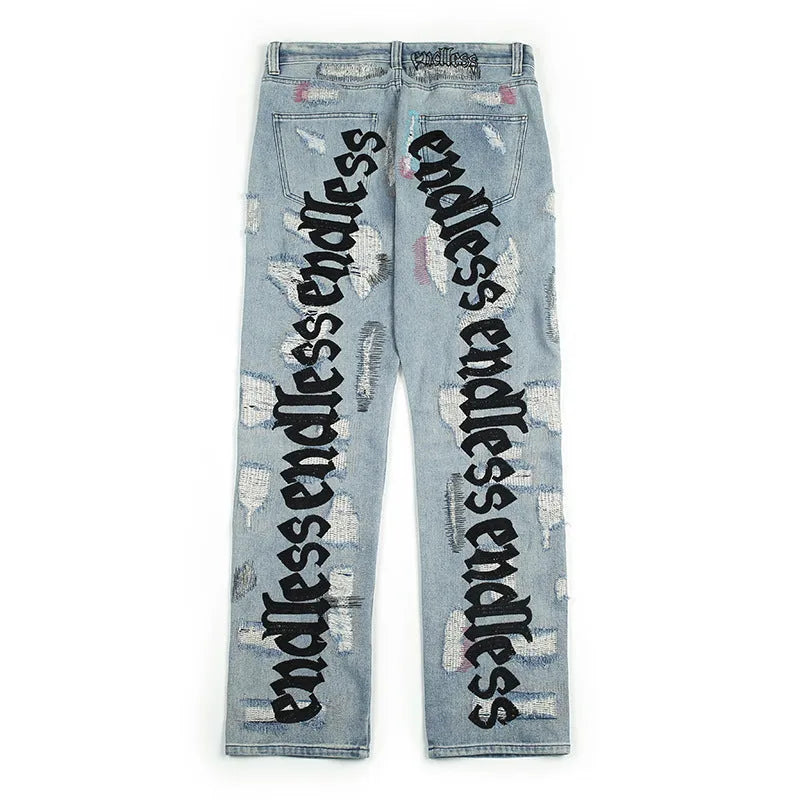 Ripped retro jeans trousers for men and women, straight loose fit, black, with embroidery and frayed details on a model standing outdoors