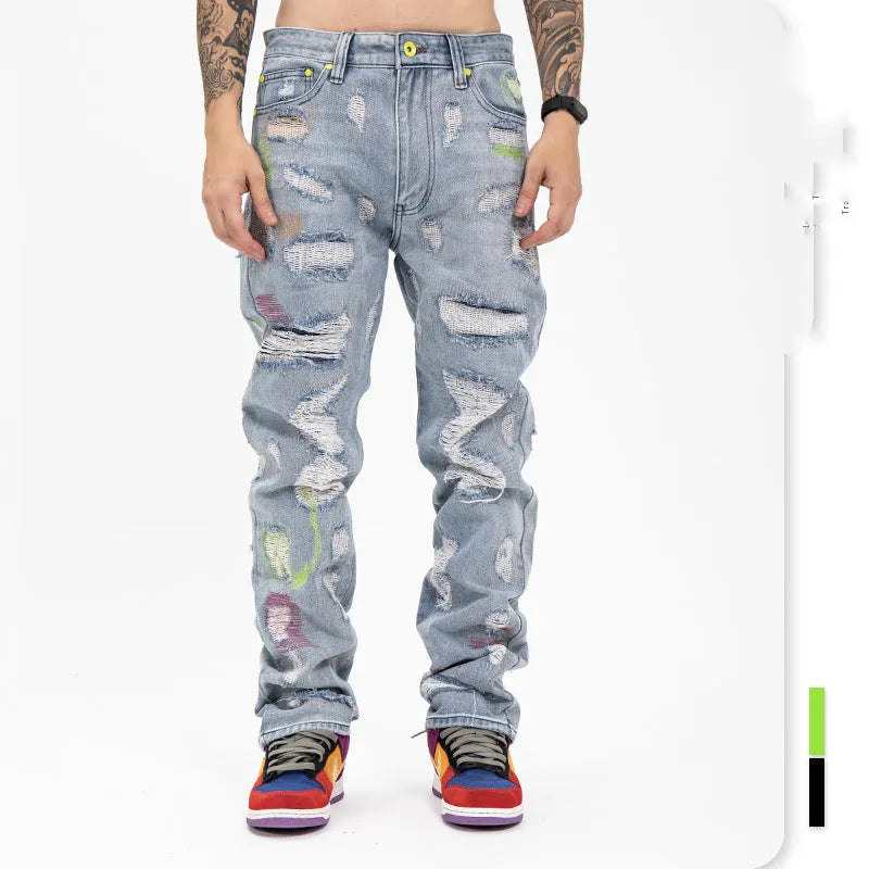 Ripped retro jeans trousers for men and women, straight loose fit, black, with embroidery and frayed details on a model standing outdoors