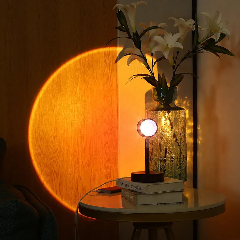 Black USB dual-head sunset rainbow projection lamp with touch control on a table.