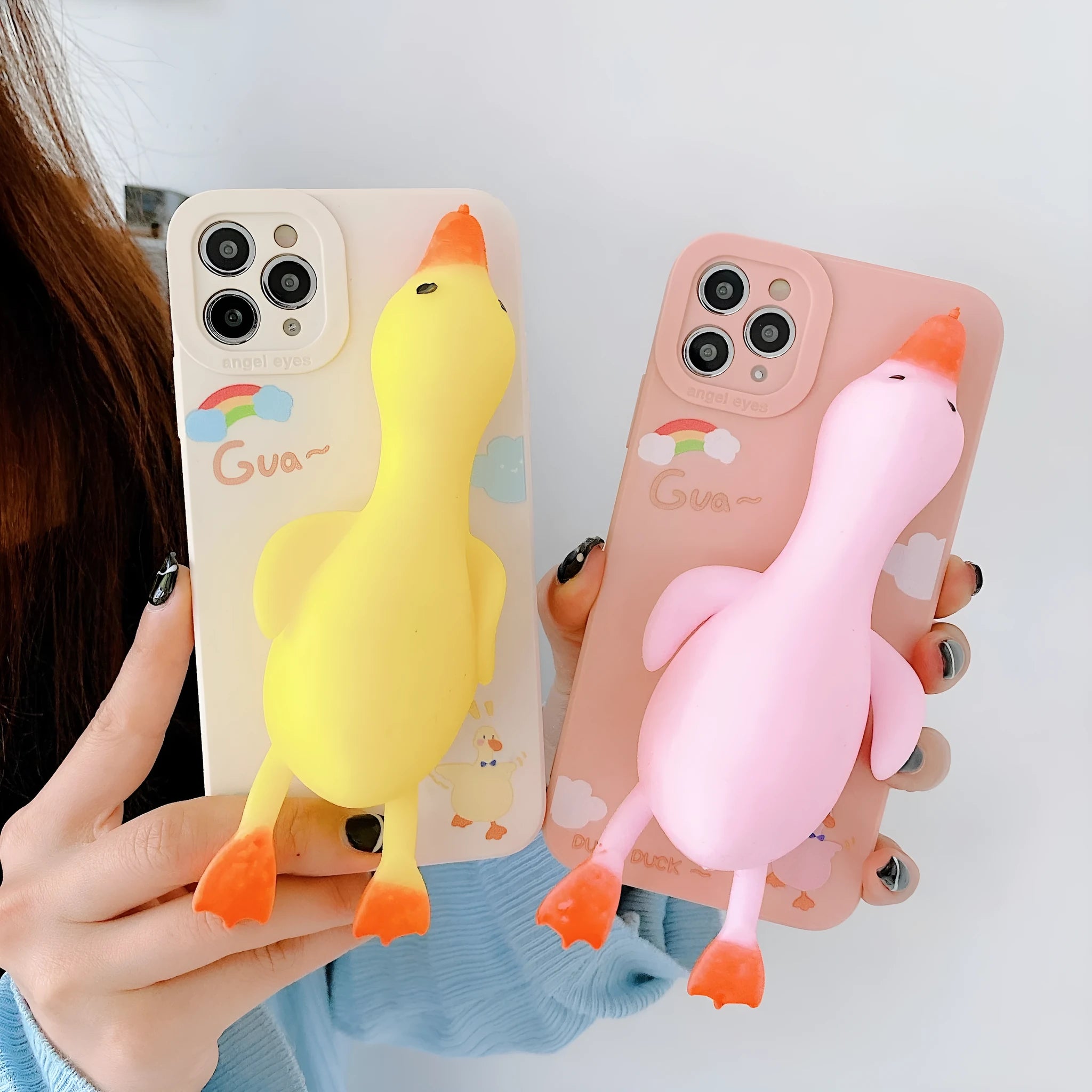 Pinch duck cartoon print silicone protective case for iPhone in yellow, white, or pink.
