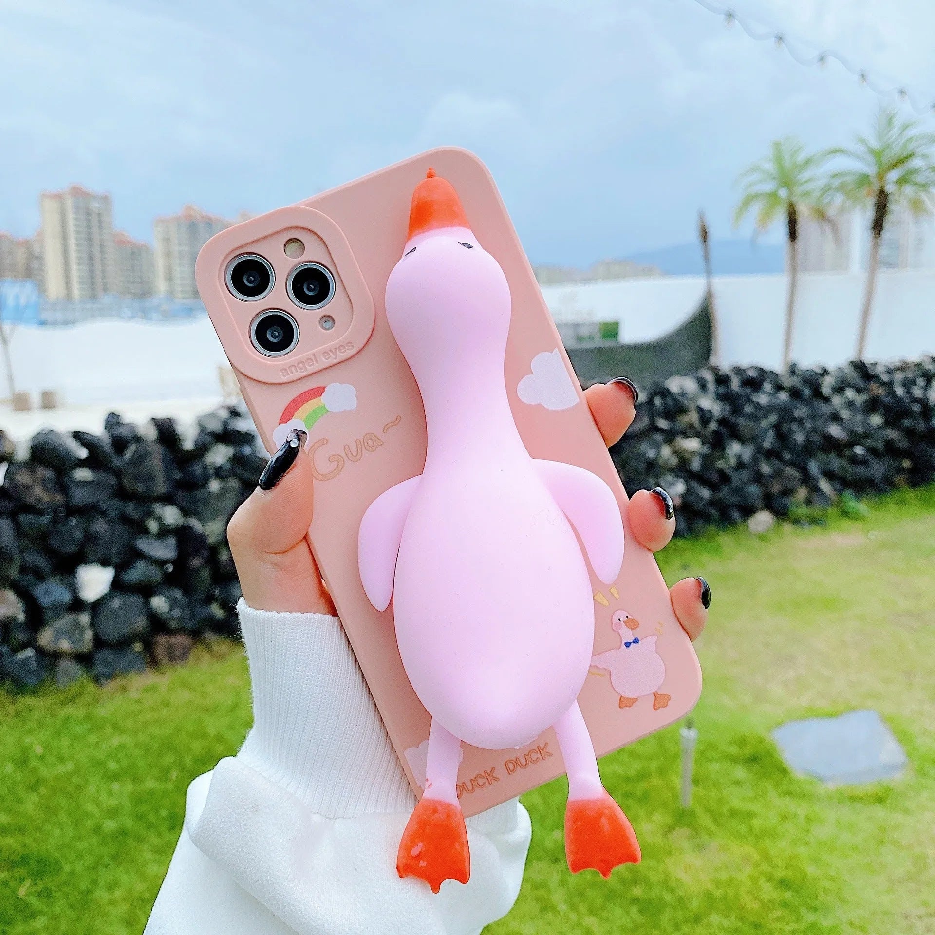 Pinch duck cartoon print silicone protective case for iPhone in yellow, white, or pink.