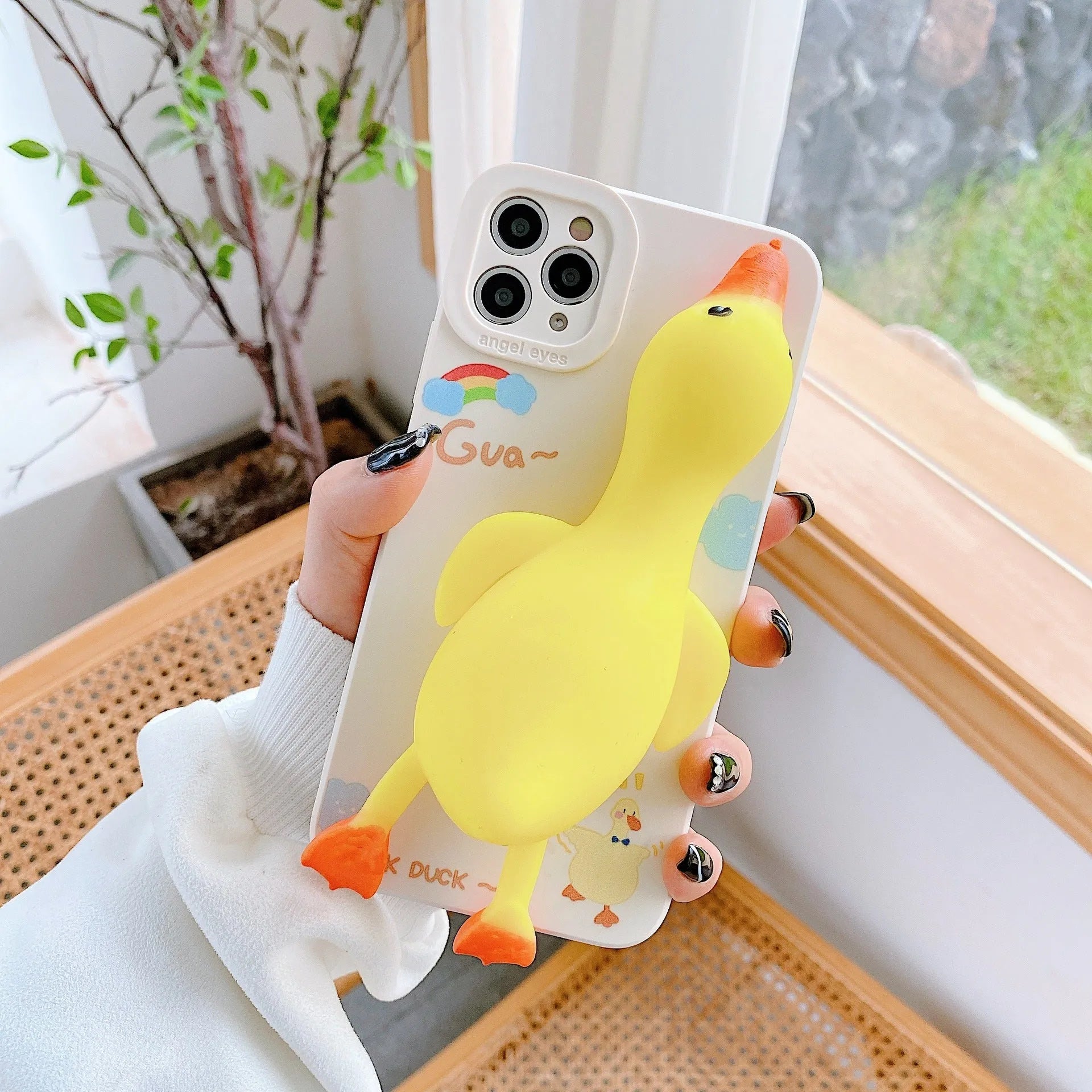 Pinch duck cartoon print silicone protective case for iPhone in yellow, white, or pink.