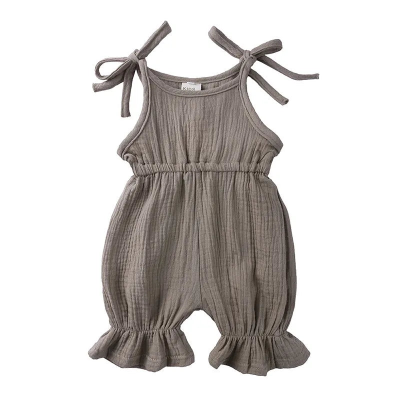 Baby girls sleeveless solid cotton romper jumpsuit in pink, front view