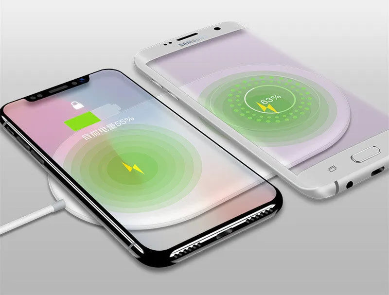 A simple white dual wireless charger for two mobile phones on a desk.