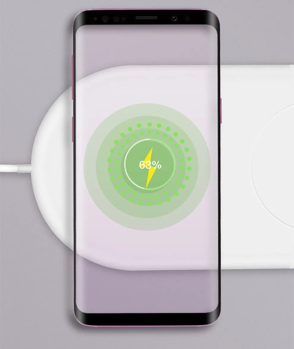 A simple white dual wireless charger for two mobile phones on a desk.