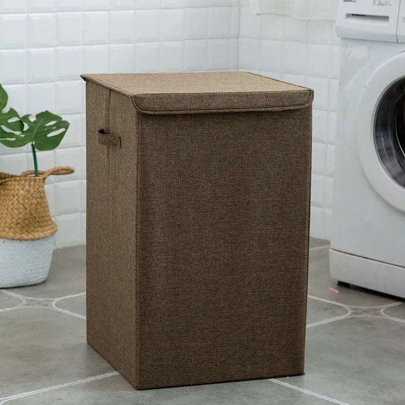 Washable fabric clothes sorting box with cover in beige, shown in a bathroom setting.