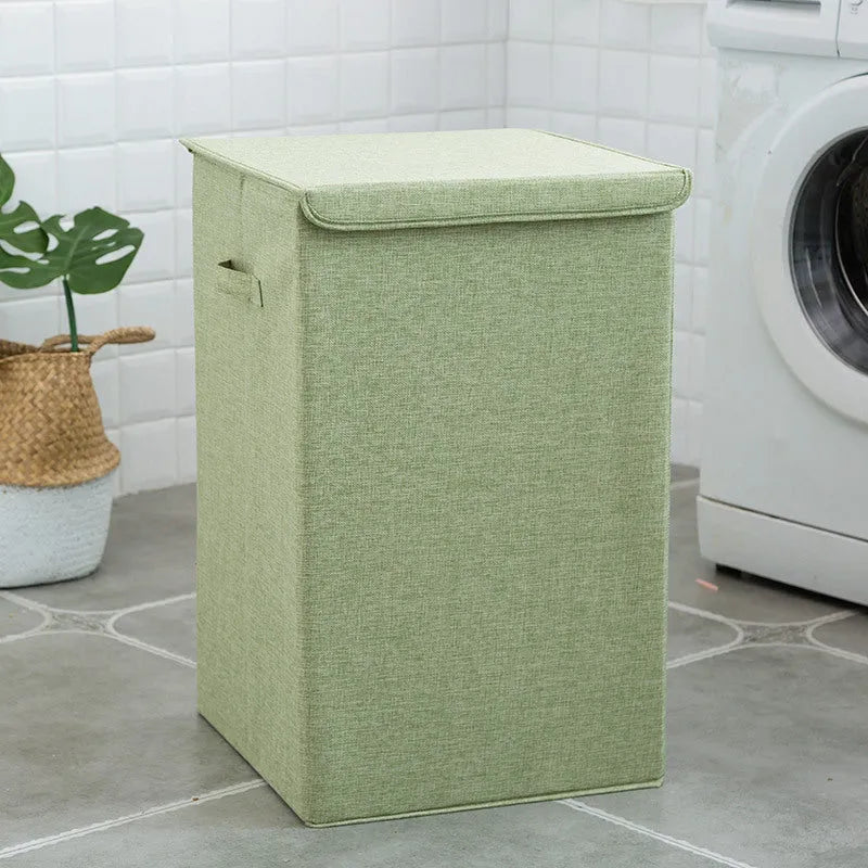 Washable fabric clothes sorting box with cover in beige, shown in a bathroom setting.