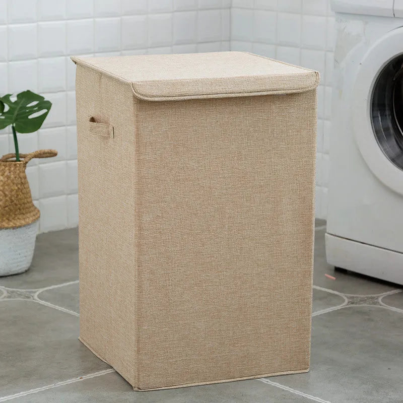 Washable fabric clothes sorting box with cover in beige, shown in a bathroom setting.