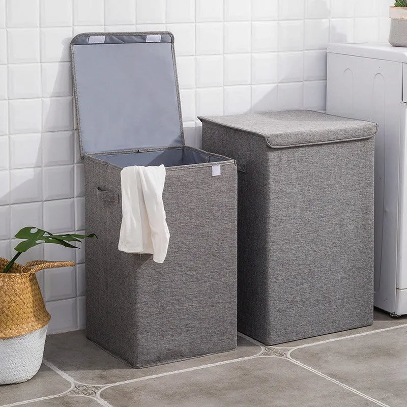 Washable fabric clothes sorting box with cover in beige, shown in a bathroom setting.