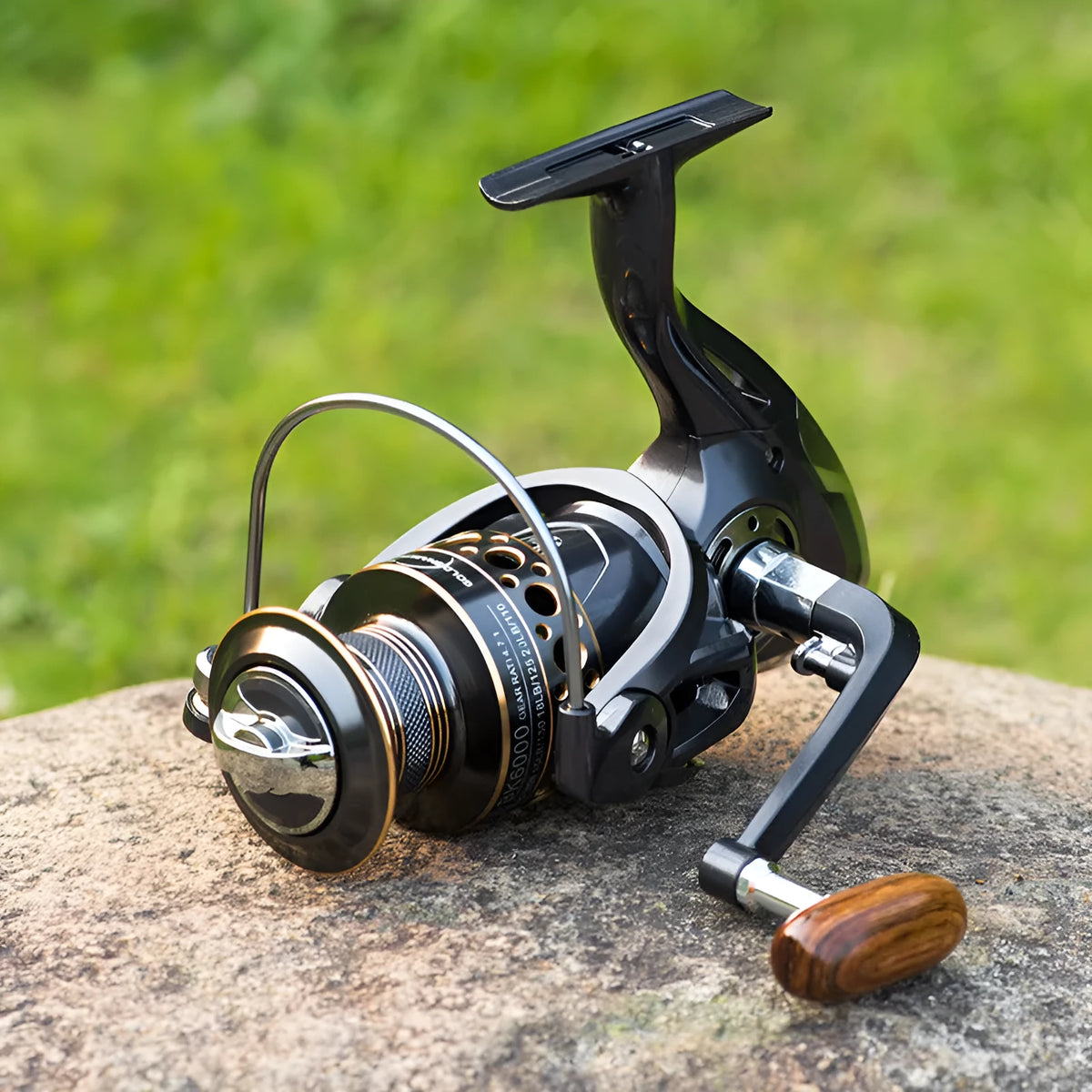 Telescopic carbon fibre fishing rod with spinning reel, solid wood handle, and metal wire cup on a rocky shore