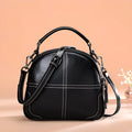 Round cowhide leather handbag with zipper closure and double strap in wine red