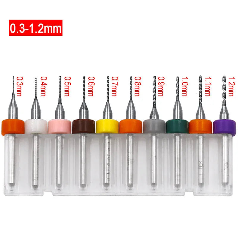 Ten tungsten carbide PCB drill bits with straight shanks on a white background