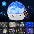 Compact plastic starry sky projector showing cosmic projection on a wall with USB cable.