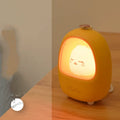 Cartoon character night light on bedside table with USB charging cable