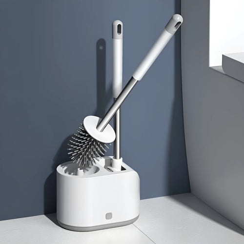 White silicone toilet brush set with long handle, soft TPR head, and second cleaning brush on a bathroom floor
