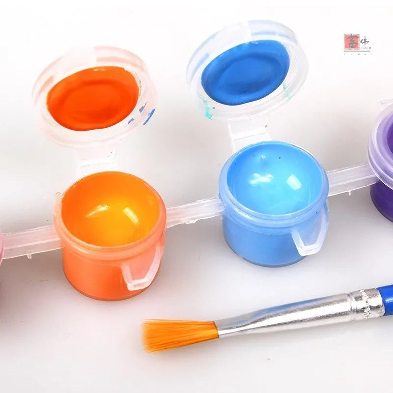 Children's gouache painting set showing sketchpad with pre-drawn pictures, rows of pigment, painting pens, and a palette.