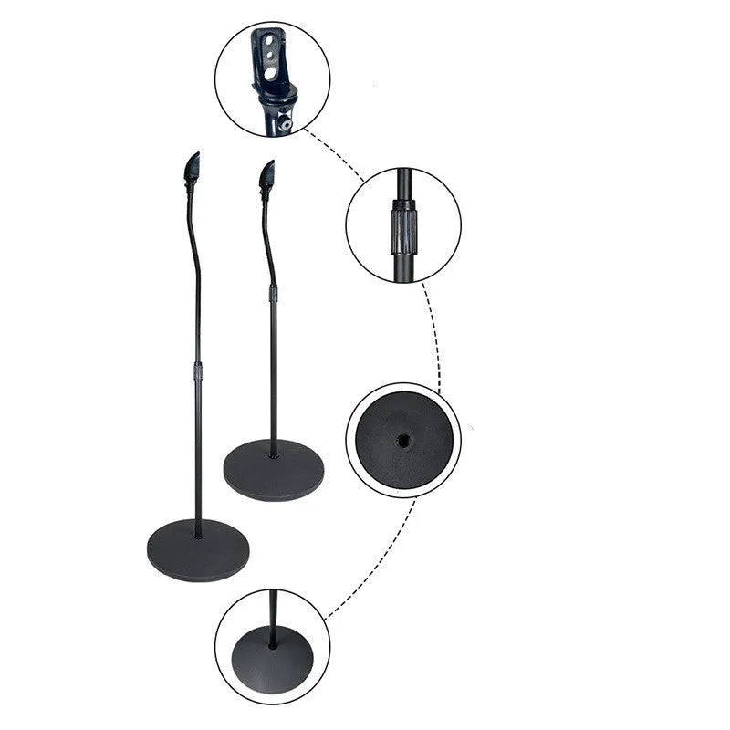 A pair of black tripod stands holding bookshelf speakers for a surround sound system.
