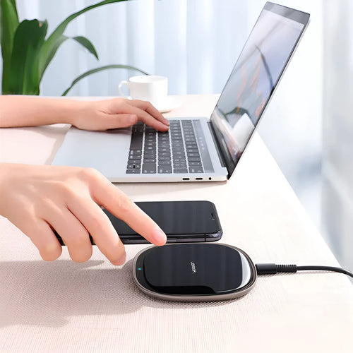 Black or white 15W wireless phone charger with zinc alloy and glass build on a desk