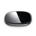Black or white 15W wireless phone charger with zinc alloy and glass build on a desk