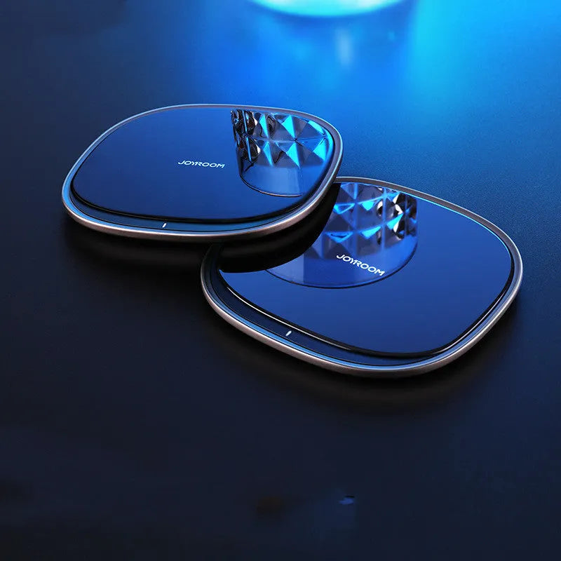 Black or white 15W wireless phone charger with zinc alloy and glass build on a desk